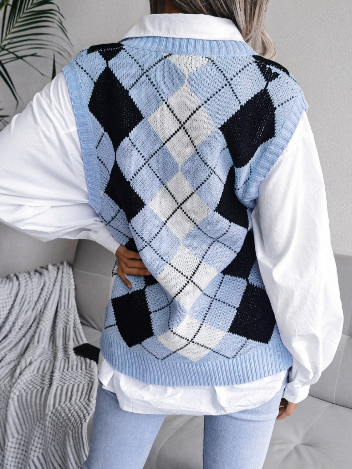 Argyle knit v-neck sweater vest in light blue with black and white diamond pattern.