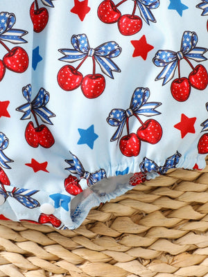 Baby one-piece with cherry and star print, cotton fabric, ruffle trim detail.