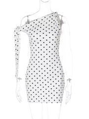 White polka dot mini dress with asymmetrical neckline and bow detail on one shoulder.