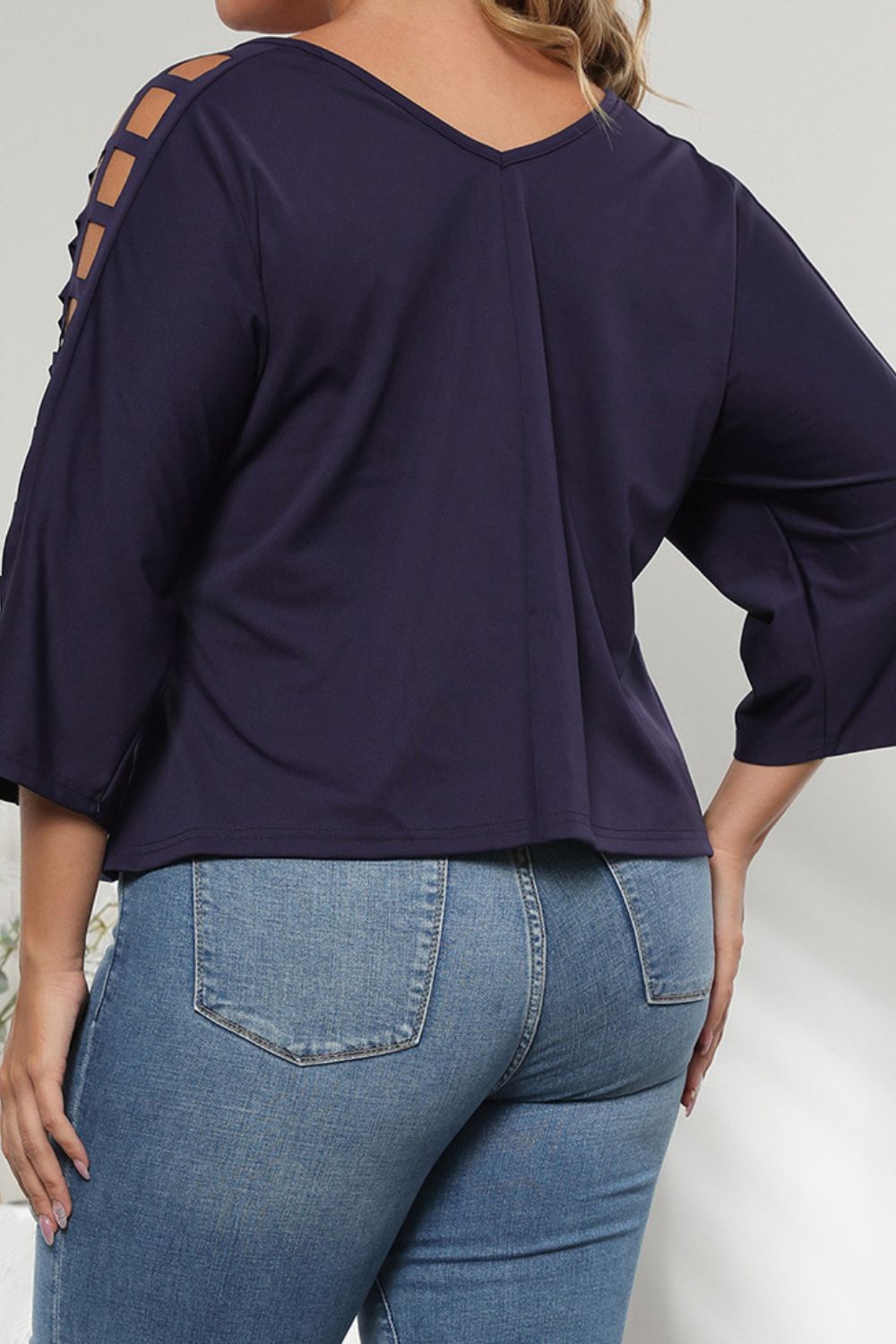 Dark navy v-neck blouse with lattice detail on the sleeves and 3/4 length sleeves.