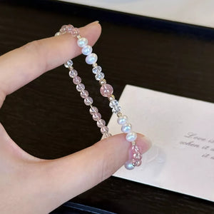 Delicate pearl and crystal bracelet with pink accents and gold beads