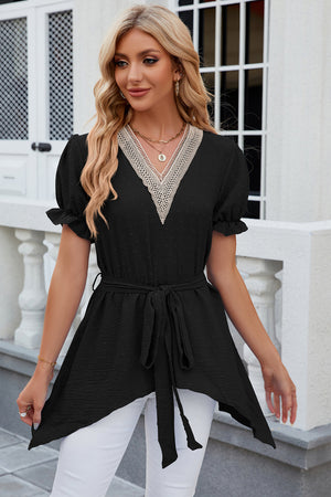 Black dotted swiss blouse with lace trim V-neck, tie waist, and asymmetric hem