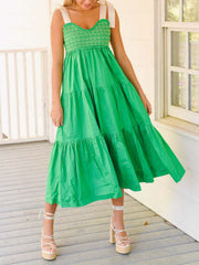 Green tie shoulder tiered midi dress with smocked bodice and flowing skirt.