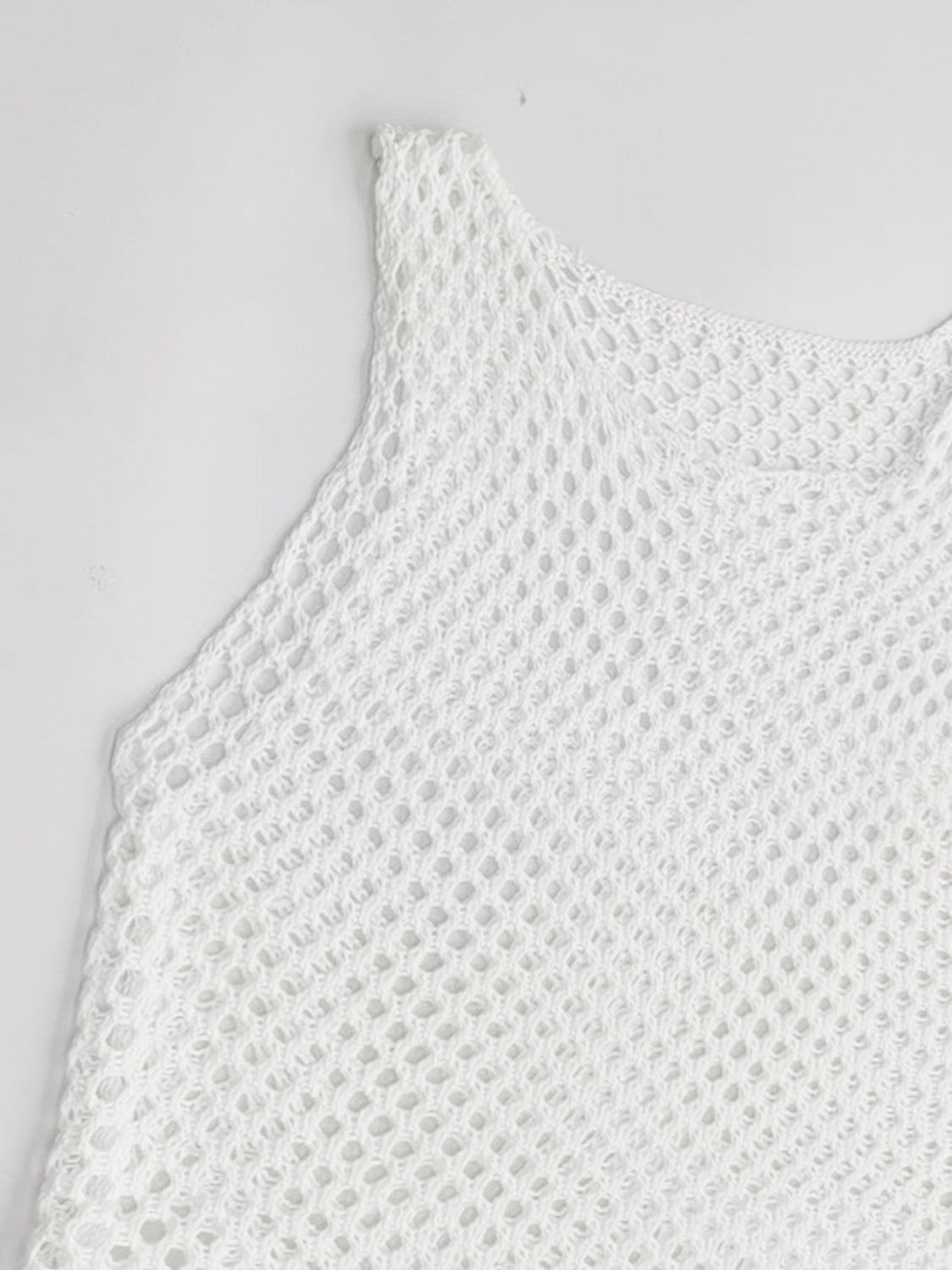White open-knit beach cover-up dress with a wide neckline and sleeveless design.