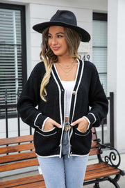 Black acrylic cardigan with white trim and pockets, button front, casual style.