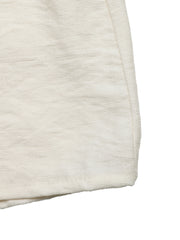 Beige tiered midi skirt with wavy trim detail and textured fabric.