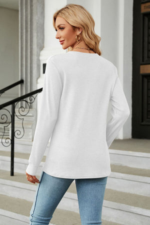 White waffle knit long sleeve top with crew neck, styled with jeans.