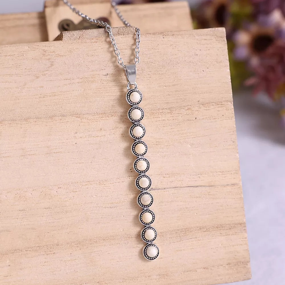 White beaded pendant necklace with alloy chain, delicate and timeless style.