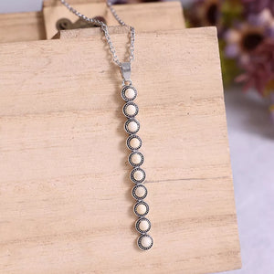 White beaded pendant necklace with alloy chain, delicate and timeless style.