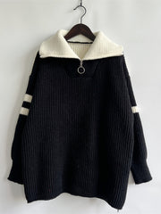 Black acrylic sweater with ribbed texture, white collar, quarter zip, and white sleeve stripes.
