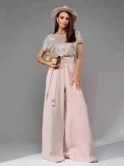 Shimmering sequin wide-leg jumpsuit with tie belt in apricot silver.