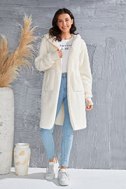 Cream plush hooded duster with thumbhole cuffs and pockets.