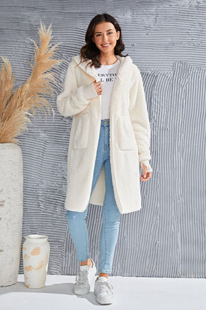 Cream plush hooded duster with thumbhole cuffs and pockets.