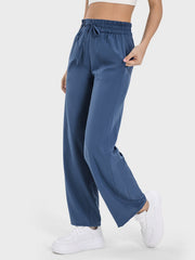 Relaxed drape drawstring palazzo pants in Dusty Blue with pockets and elastic waistband.