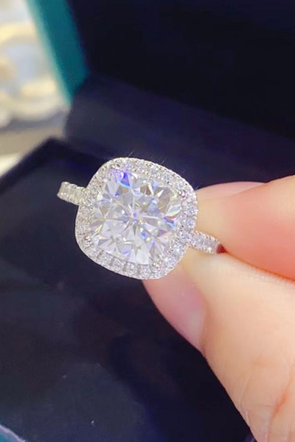 White cushion-cut halo engagement ring with diamond band