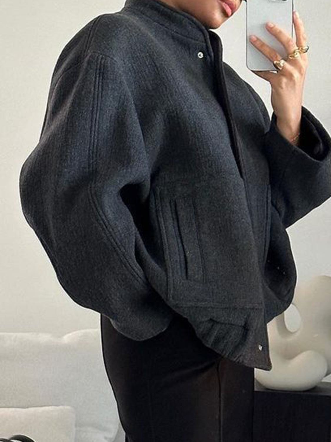 Dark Gray bouclé cocoon jacket with snap closure and textured pockets.