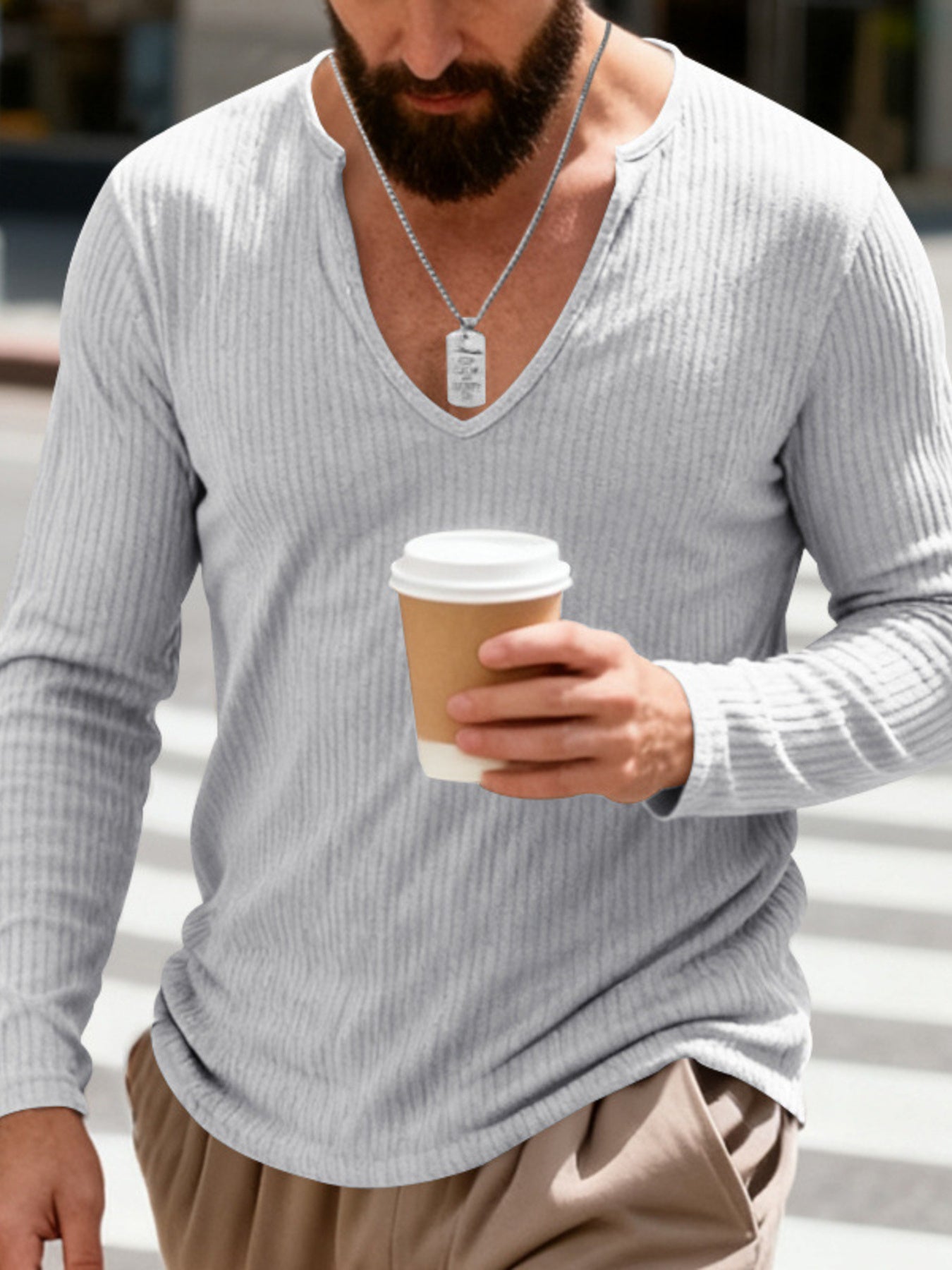 Light gray ribbed long sleeve t-shirt with a deep V-neck, worn by a man holding a coffee cup.