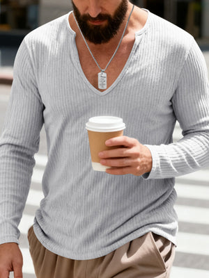 Light gray ribbed long sleeve t-shirt with a deep V-neck, worn by a man holding a coffee cup.