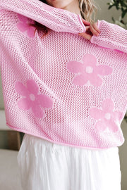 Openwork blush pink acrylic sweater with floral intarsia pattern and crew neck.