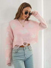 Distressed blush pink knit cropped sweater with white butterfly print and frayed hem.