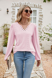 Blush pink eyelet yoke blouse with blouson sleeves and v-neckline