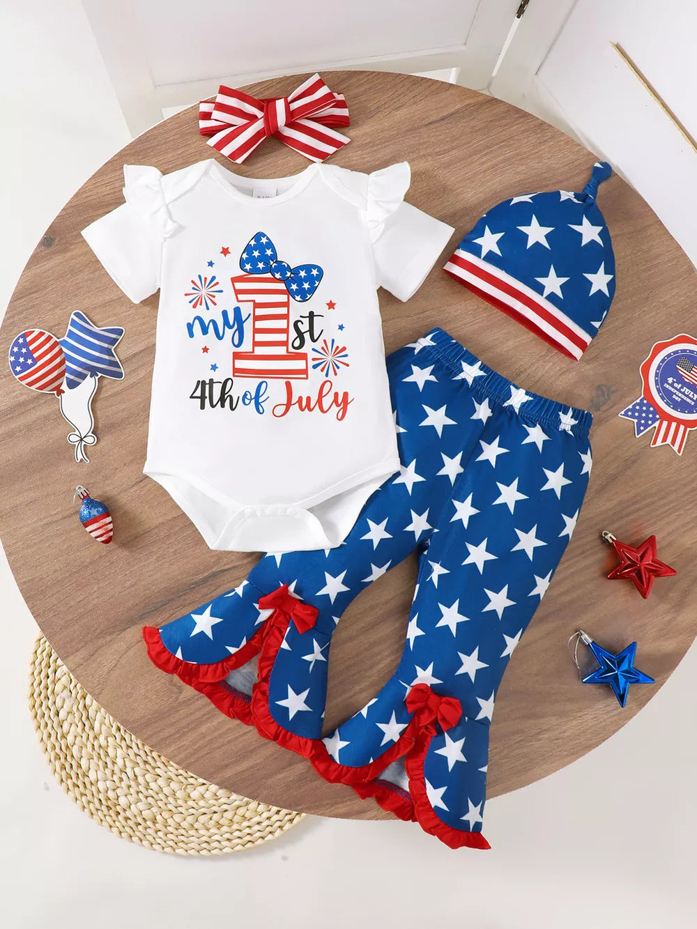 Patriotic baby bodysuit with ruffle sleeves and flare pants set, featuring stars and 4th of July graphic.