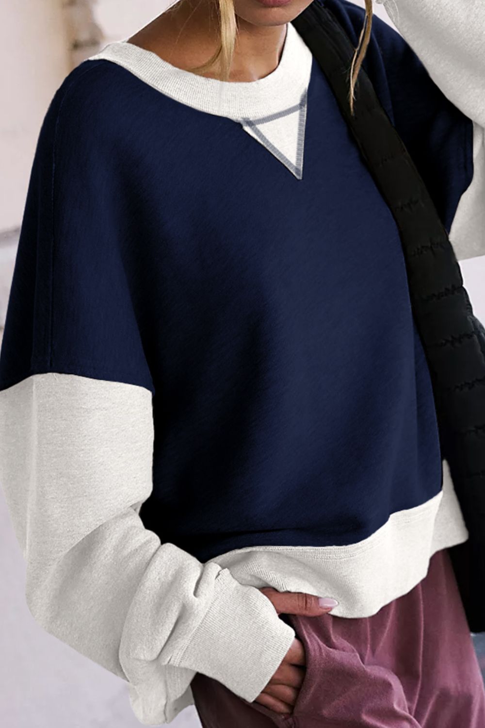 Navy and white colorblock crewneck sweatshirt with contrast stitching detail.