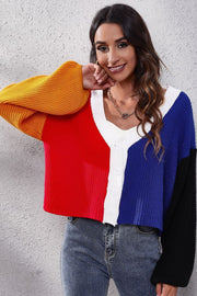 Panelled ribbed knit cardigan with colorblock design in red, blue, yellow, white, and black.