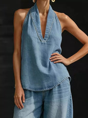 Blue denim halter neck top with deep V-neck and wide-leg pants ensemble.