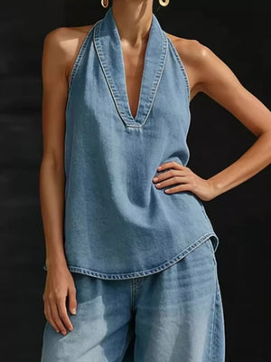 Blue denim halter neck top with deep V-neck and wide-leg pants ensemble.