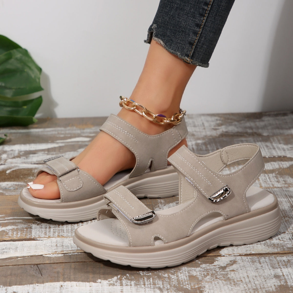 Gray adjustable open-toe sandals with contrast stitching and buckle details.