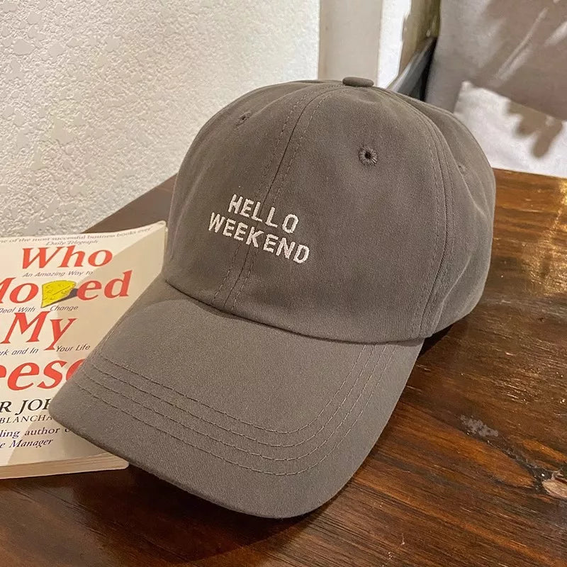 Grey cotton baseball cap with white "HELLO WEEKEND" embroidery