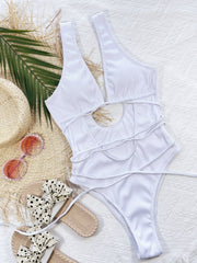 White ribbed one-piece swimsuit with plunging neckline, cut-out detail, and wrap-around ties.