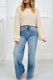 High-rise wide leg jeans in light wash denim with distressed details and raw hem.