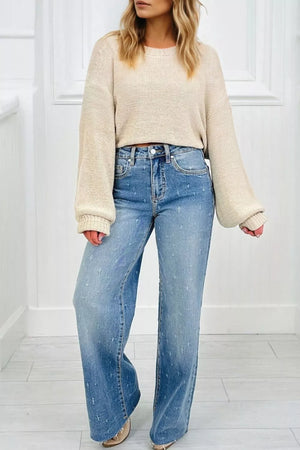 High-rise wide leg jeans in light wash denim with distressed details and raw hem.