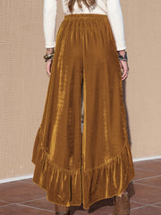 Velvet ruffle slit palazzo pants in caramel with wide legs and a ruffled hem.