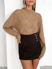 Camel textured chevron knit pullover sweater with bobble details and mock neckline.