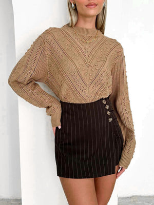 Camel textured chevron knit pullover sweater with bobble details and mock neckline.