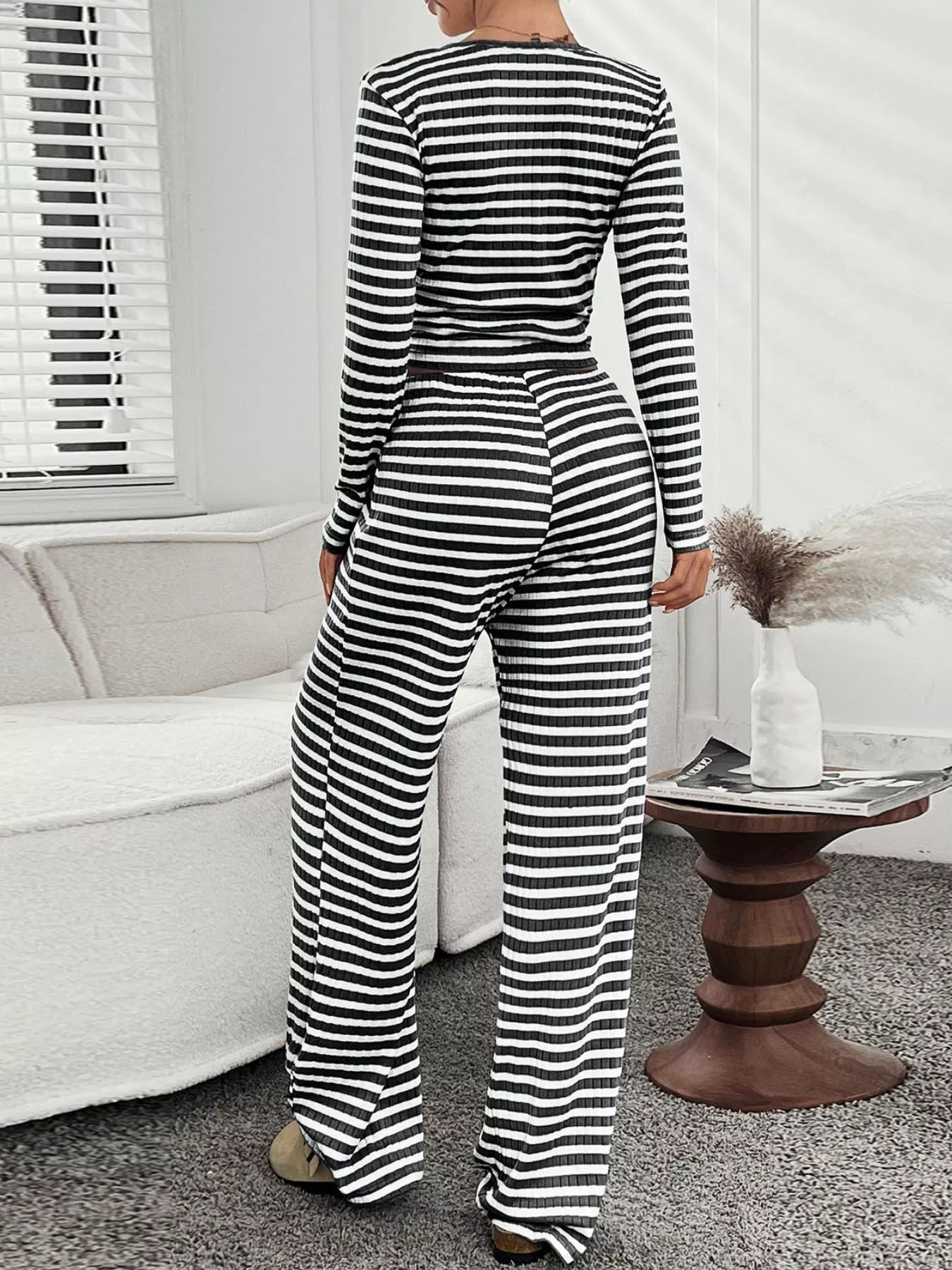 Black and white striped loungewear set with long sleeves and wide-leg pants.
