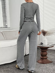 Black and white striped loungewear set with long sleeves and wide-leg pants.