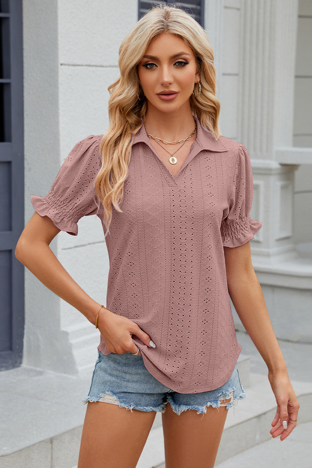 Blush pink eyelet polo blouse with short ruched sleeves.