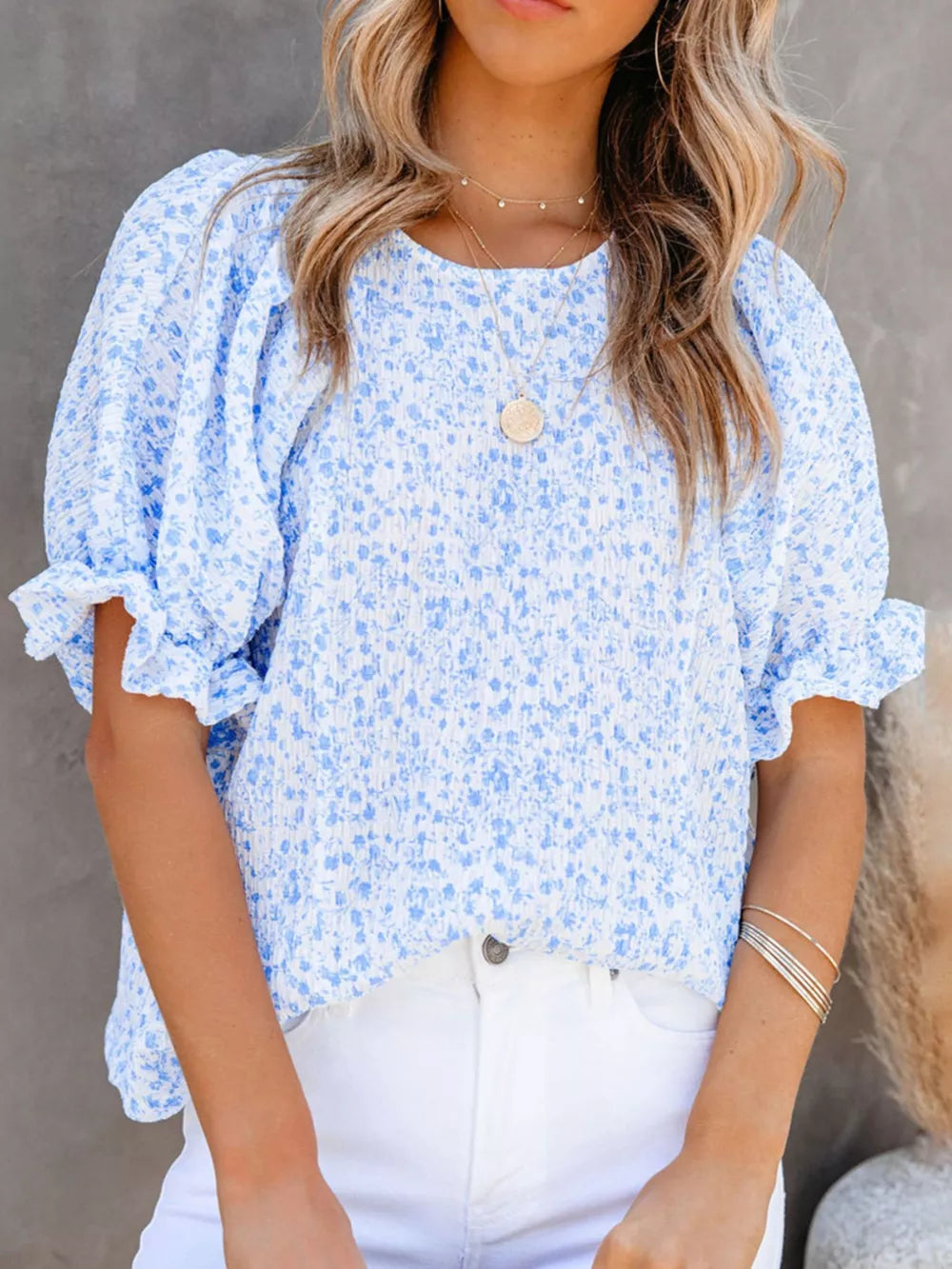 Sky blue floral print maternity blouse with ruffle sleeves and smocked bodice.