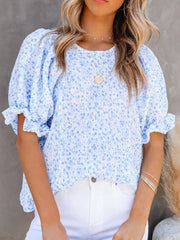 Sky blue floral print maternity blouse with ruffle sleeves and smocked bodice.