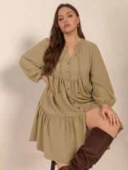Olive green button-front tie-neck dress with balloon sleeves and tiered skirt.