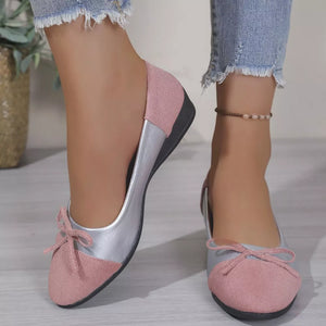Pink and silver slip-on flats with bow detail.