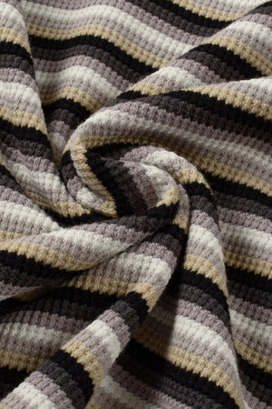 Cotton culotte joggers with horizontal stripes in black, beige, grey, and white.