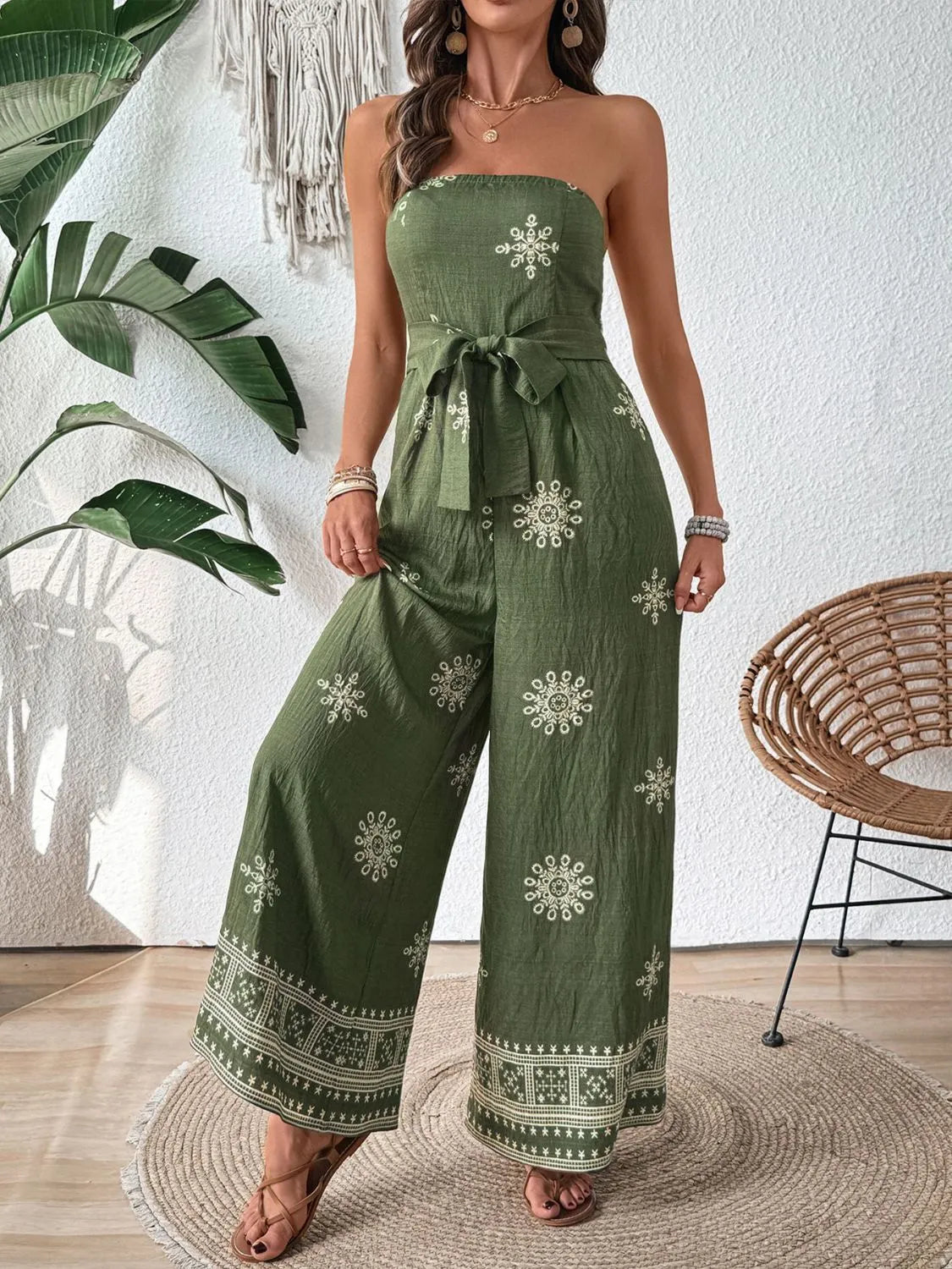 Matcha green bandeau jumpsuit with embroidered floral pattern and wide legs.
