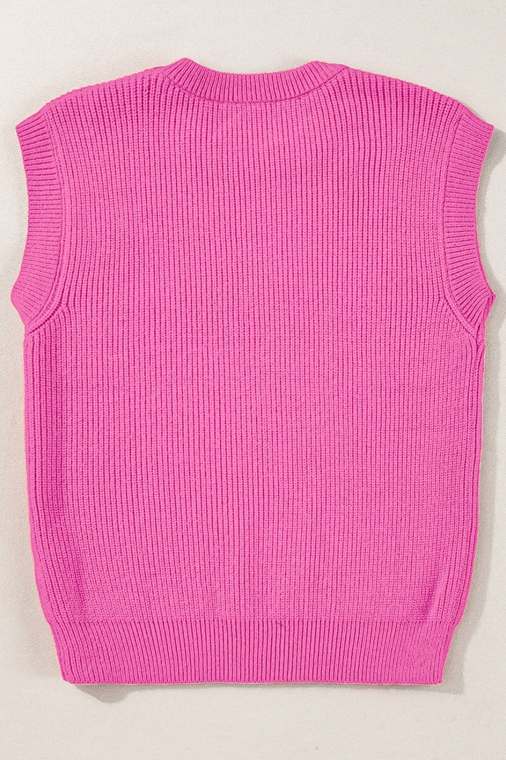 Fuchsia pink ribbed knit vest with a crew neck and sleeveless design.