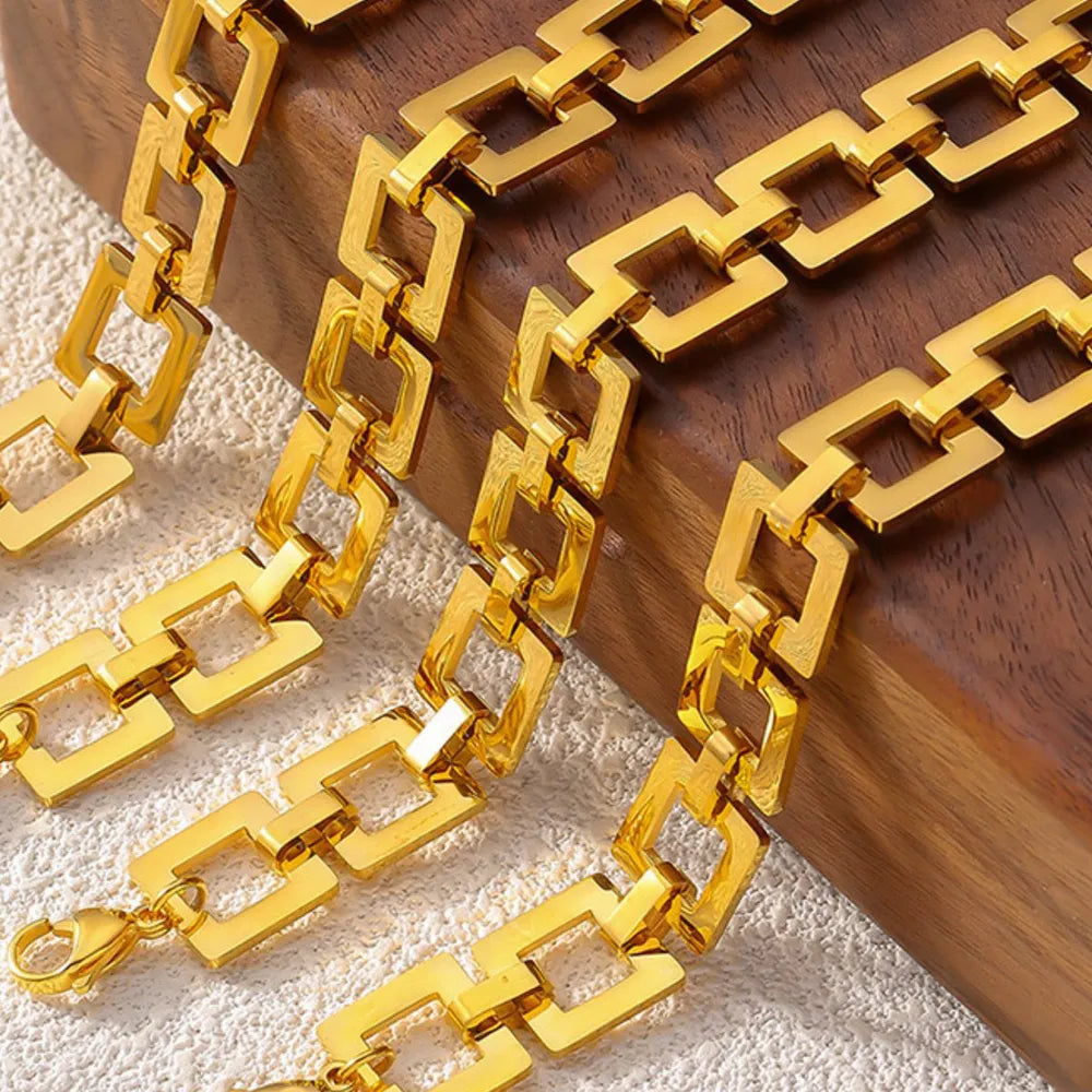Gold geometric link bracelet with bold square links and a lobster clasp.