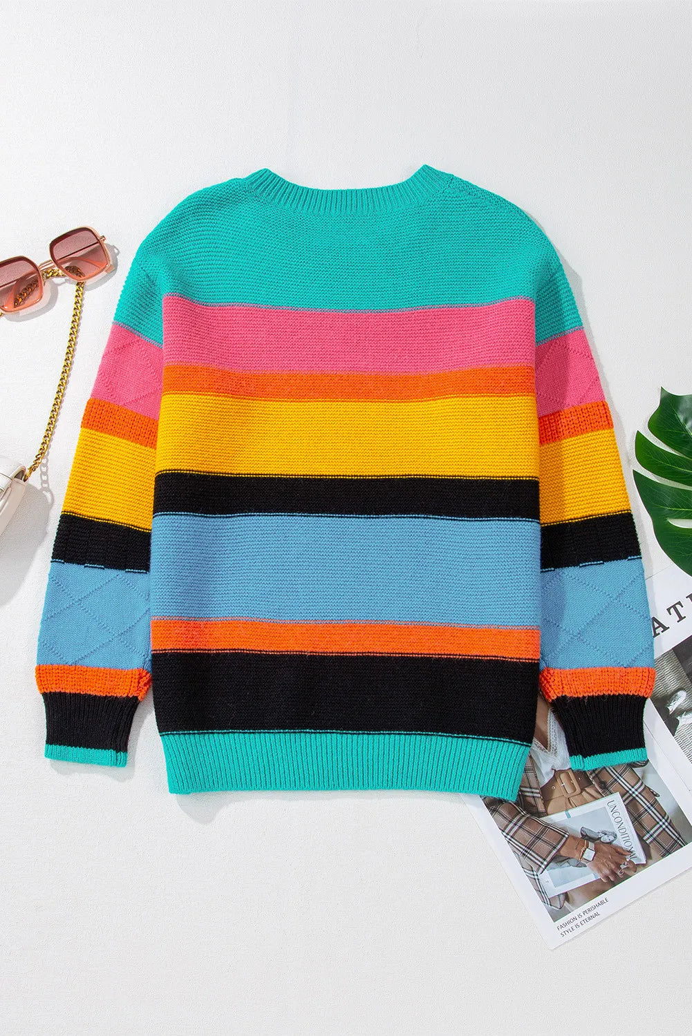 Rainbow stripe knit crewneck sweater in turquoise and pastel blue with multicolor stripes and diamond pattern on sleeves.